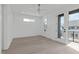 Bright bedroom features hardwood floors, a ceiling fan, and French doors to a balcony that lets the sun shine in at 227 Woodsborough Pl, Raleigh, NC 27601