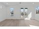 Bright bedroom featuring hardwood floors, large windows, and French doors to let the sun shine in at 227 Woodsborough Pl, Raleigh, NC 27601
