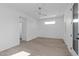 Bright bedroom featuring hardwood floors, white walls, a ceiling fan, and a view of the en suite bathroom at 227 Woodsborough Pl, Raleigh, NC 27601