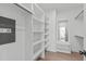 Spacious walk-in closet with custom shelving and a built-in safe for secure storage at 227 Woodsborough Pl, Raleigh, NC 27601