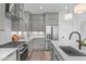 A kitchen with stainless steel appliances, quartz countertops and stylish gray cabinets at 227 Woodsborough Pl, Raleigh, NC 27601
