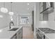 Open kitchen design with island, stainless steel appliances, and stylish pendant lighting at 227 Woodsborough Pl, Raleigh, NC 27601