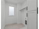 Bright laundry room featuring sleek, white cabinets and a functional layout for efficient organization and convenience at 227 Woodsborough Pl, Raleigh, NC 27601