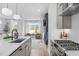 Open floor plan connecting kitchen and living room, filled with natural light from large windows at 227 Woodsborough Pl, Raleigh, NC 27601