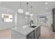 Open-concept living area with modern island, and abundant natural light at 227 Woodsborough Pl, Raleigh, NC 27601