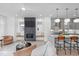 Cozy living area flowing into a modern kitchen with island and stylish pendant lighting at 227 Woodsborough Pl, Raleigh, NC 27601