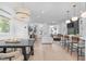 Open-concept living space with hardwood floors seamlessly connects kitchen, dining, and living areas at 227 Woodsborough Pl, Raleigh, NC 27601