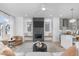 Contemporary living room with a sleek fireplace, built-in benches and light hardwood flooring at 227 Woodsborough Pl, Raleigh, NC 27601
