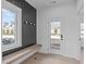 Stylish mud room features a wood bench, a coat rack, black accent wall and an abundance of natural light at 227 Woodsborough Pl, Raleigh, NC 27601