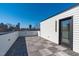 Rooftop deck with wooden tiles and cityscape view, perfect for outdoor living at 227 Woodsborough Pl, Raleigh, NC 27601