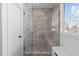 Modern walk-in shower with sleek glass door and tiled walls, offering a spa-like experience at 227 Woodsborough Pl, Raleigh, NC 27601