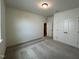 A bright bedroom with a window, carpeted floors and double door closet at 235 Chestnut Oak Ln, Lillington, NC 27546