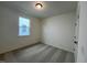 A bright bedroom with a window provides natural light and has carpet flooring at 235 Chestnut Oak Ln, Lillington, NC 27546