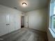 A well-lit bedroom with a window, carpeted floors and double door closet at 235 Chestnut Oak Ln, Lillington, NC 27546