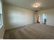 A cozy bedroom features neutral walls, carpeted floors, and natural light from a window at 235 Chestnut Oak Ln, Lillington, NC 27546