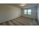 A well-lit bedroom with carpet flooring, natural light and neutral colored walls at 235 Chestnut Oak Ln, Lillington, NC 27546