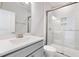 Bright bathroom featuring glass shower, neutral tile surround and white vanity with gray hardware at 103 W Star Foal Ln, Wendell, NC 27591