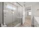 Bright bathroom featuring a glass shower with a built-in seat and a view into an adjacent room at 103 W Star Foal Ln, Wendell, NC 27591