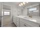 Modern bathroom featuring double sinks, a glass shower, and neutral tile at 103 W Star Foal Ln, Wendell, NC 27591