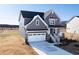 New two-story home featuring a two car garage, covered porch, and neutral gray siding at 103 W Star Foal Ln, Wendell, NC 27591