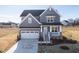 Two-story gray house with white garage door and landscaping at 103 W Star Foal Ln, Wendell, NC 27591
