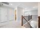 Hallway featuring wood and black iron railing and neutral walls and carpeting at 103 W Star Foal Ln, Wendell, NC 27591