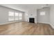 A living room with neutral walls, hardwood floors, and modern fireplace at 103 W Star Foal Ln, Wendell, NC 27591
