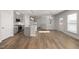Open-concept living room featuring sleek hardwood floors and modern, neutral paint at 103 W Star Foal Ln, Wendell, NC 27591