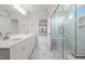 Bright bathroom featuring double vanity and glass-enclosed shower with marble tile and seating at 22 Belmont Stakes Ln, Wendell, NC 27591