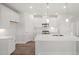Bright, all-white kitchen with a large center island and modern appliances at 22 Belmont Stakes Ln, Wendell, NC 27591