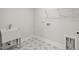 Laundry room featuring a utility sink and patterned tile flooring at 22 Belmont Stakes Ln, Wendell, NC 27591