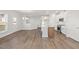 Open-concept living space with wood floors, connecting kitchen and dining areas at 22 Belmont Stakes Ln, Wendell, NC 27591