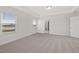 Spacious carpeted main bedroom with tray ceilings and large windows at 22 Belmont Stakes Ln, Wendell, NC 27591