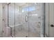 Detail of marble-tiled shower featuring a glass door and a built-in bench seat at 22 Belmont Stakes Ln, Wendell, NC 27591