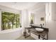 Modern bathroom with double vanity, soaking tub, and large window offering a scenic view at 4416 Arrowhead Trl, Hillsborough, NC 27278
