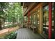 Wooden deck with red railings, offering a view of the wooded surroundings at 4416 Arrowhead Trl, Hillsborough, NC 27278