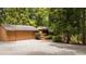 Detached garage with gravel driveway and surrounded by trees at 4416 Arrowhead Trl, Hillsborough, NC 27278
