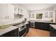 Modern kitchen with stainless steel appliances and wood floors at 4416 Arrowhead Trl, Hillsborough, NC 27278