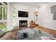 Modern living room with fireplace and large windows at 4416 Arrowhead Trl, Hillsborough, NC 27278