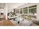 Bright living room with large windows, fireplace, and hardwood floors at 4416 Arrowhead Trl, Hillsborough, NC 27278