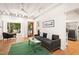 Bright living room with hardwood floors, a comfortable sofa, and access to a deck at 4416 Arrowhead Trl, Hillsborough, NC 27278