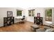 Home office with hardwood floors, built-in shelving, and a view of the woods at 4416 Arrowhead Trl, Hillsborough, NC 27278