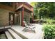 Relaxing patio with lounge chairs and a grill, overlooking the woods at 4416 Arrowhead Trl, Hillsborough, NC 27278