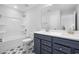 Beautiful bathroom features a double vanity with modern fixtures, tub with shower, and designer tile floor at 75 E Star Foal Ln, Wendell, NC 27591