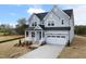 Beautiful two-story home with a two-car garage, well-maintained landscaping, and classic architectural details at 75 E Star Foal Ln, Wendell, NC 27591