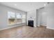 Bright living room featuring hardwood floors, a fireplace, and large windows offering natural light at 75 E Star Foal Ln, Wendell, NC 27591