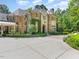 Stone and stucco home with a large driveway and manicured landscaping at 50211 Manly, Chapel Hill, NC 27517