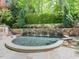 Backyard pool with a stone waterfall feature and lush landscaping at 50211 Manly, Chapel Hill, NC 27517