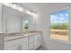 Bright bathroom with double vanity, granite countertop, and a window at 953 Alma Railway Dr, Wake Forest, NC 27587