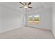 Bright bedroom features neutral carpet, natural light, and a ceiling fan at 953 Alma Railway Dr, Wake Forest, NC 27587